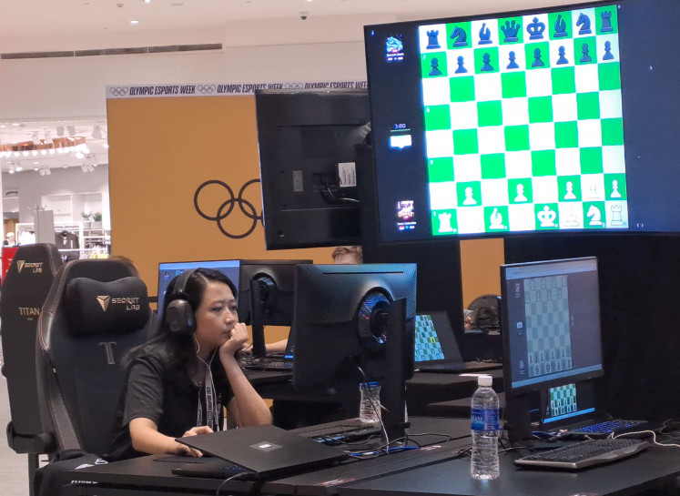 Indonesian chess player Irene Sukandar contemplates as she plays white in the second match of the pool stage of Olympic Esports Week 2023 in Suntec City, Singapore, on June 23, 2023.