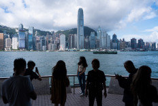 Mainland Chinese tourists visit a promenade next to Victoria Harbour in Hong Kong, China, on June 20, 2023.
