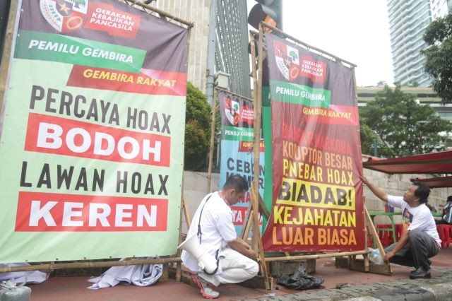 War on hoaxes: Members of a group claiming to defend Pancasila ideology place banners that call for a fight against hoaxes and hate speech near the Hotel Indonesia traffic circle in Jakarta on Jan. 27, 2019, a few months ahead of the election.