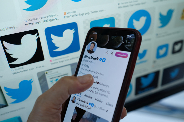 This illustration photo taken in Los Angeles on April 20, 2023, shows Elon Musk's Twitter page on a smartphone. Musk announced on July 1, 2023, that Twitter would temporarily restrict how many tweets users could read per day, in a move meant to tamp down on the use of the site's data by artificial intelligence companies.