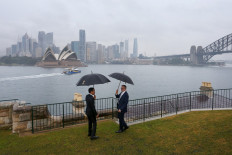 Australian Prime Minister Anthony Albanese (right) speaks with Indonesian President Joko "Jokowi" Widodo (left) on July 4, 2023, in front of the Opera House and city skyline in Sydney, Australia. 