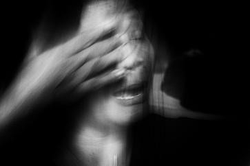 Yati, 57, wipes her tears as she recounts her troubled times with her husband.