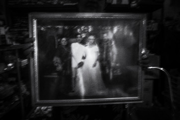 Musriyah shows a family picture taken during her daughter’s marriage.