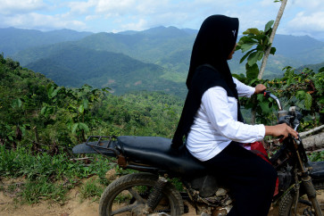 Every two days, Ike Ernawati, 32, visits six families with toddlers and pregnant mothers in Mulyorejo village, Silo subdistrict, Jember regency, East Java.