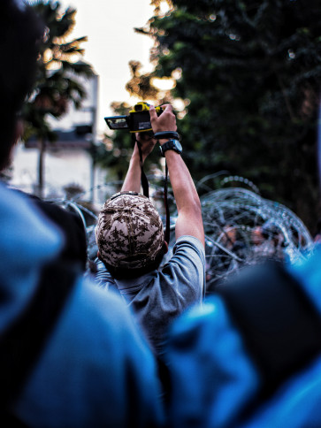A photographer at a Bandung demonstration in April 2022.