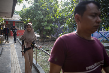 Atung Yunarto (right) and RBS Distribution Coordinator Hannan Abdullah (center) walks down the guiding block while doing an interview for a podcast on the RBS YouTube channel.