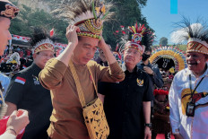 President Joko “Jokowi“ Widodo wears traditional Papuan headwear during the inauguration of a creative hub for Papuan youths in Jayapura, Papua province, on March 21, 2023.