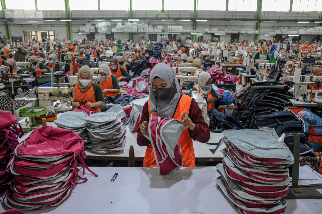 Workers produce backpacks on June 14, 2023, at a factory owned by PT Eksonindo Multi Product Industry in Katapang, Bandung regency, West Java. The company produces up to 6,000 backpacks on a daily basis for local brands Eiger, Bodypack and Exsport.
