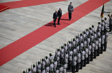 German Chancellor Olaf Scholz (left) and Australian Prime Minister Anthony Albanese (center) review a military honor guard during an official welcoming ceremony at the Chancellery in Berlin on July 10, 2023. 
