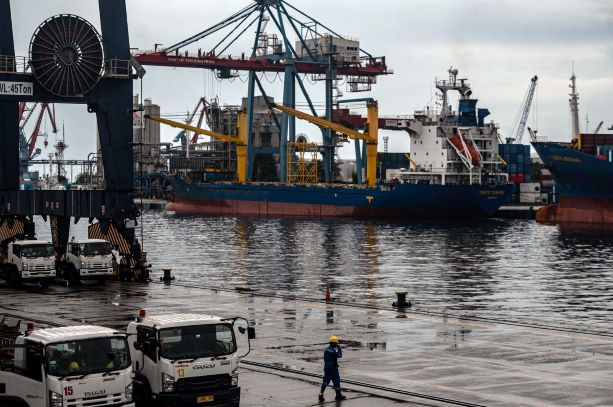 Man at work: A worker walks down the container terminal in Tanjung Priok port in North Jakarta on June 16, 2023. Statistics Indonesia (BPS) reported a trade surplus of US$440 million in May of this year.