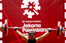 Sri Wahyuni Agustiani of Indonesia competes in the women's 48kg weightlifting event during the 2018 Asian Games in Jakarta on August 20, 2018. 