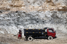 Workers operate a tool to break limestone into small pieces in the Klapanunggal limestone hill - Bogor Regency, West Java (Friday, December 3, 2021). Even though they are assisted by small machines, they prefer to work manually. 