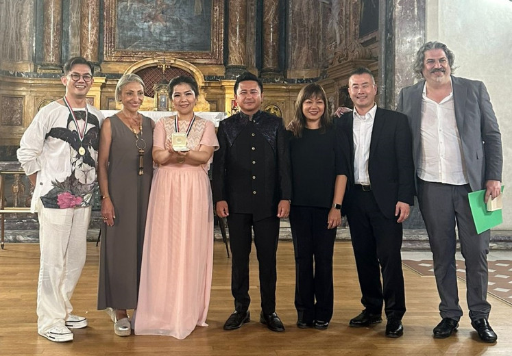The Resonanz Children's Choir (TRCC) trainer Rainer Revireino (left) and conductor Luciana Oendoen (second left) receive the Grand Prix award at the Leonardo Da Vinci International Choral Festival in Florence, Italy.