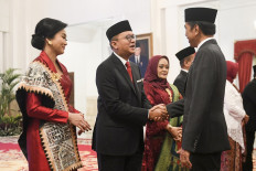 President Joko “Jokowi“ Widodo (right) shakes hands with new Deputy State Owned Enterprises (SOE) Minister Rosan Roeslani after his inauguration ceremony at the State Palace in Jakarta on July 17, 2023. 