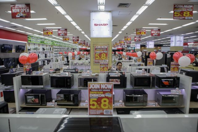 Employees arrange products during the opening of Yamada Best in Summarecon Mall in Serpong, South Tangerang city, Banten, on July 11, 2023. The shop is the eighth outlet of the Japanese electronics chain in Indonesia.