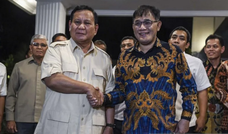 Defense Minister Prabowo Subianto (left) shakes hands with Indonesian Democratic Party of Struggle (PDI-P) politician Budiman Sudjatmiko in Jakarta on July 18, 2023.