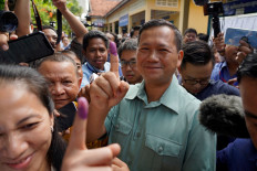 Hun Manet, former commander of the Royal Cambodian Army and eldest son of Prime Minister Hun Sen, shows his finger after he casts his vote at a polling station in Phnom Penh on July 23, 2023.