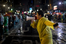 A pro-democracy protester shouts through a megaphone during a demonstration in support of the Move Forward Party in Bangkok on July 23, 2023 after Thailand's parliament blocked the party leader Pita Limjaroenrat's prime ministerial nomination.