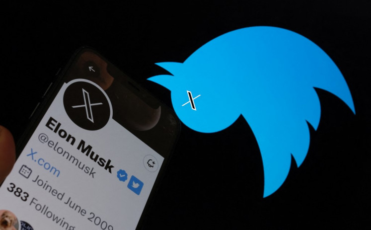 This illustration photo taken on July 24, 2023 shows the Twitter bird logo upside down in the background of Elon Musk’s screen advertising an “X“ as a replacement logo, in Los Angeles. Elon Musk killed off the Twitter logo on July 24, 2023, replacing the world-recognized blue bird with a white X as the tycoon accelerates his efforts to transform the floundering social media giant.