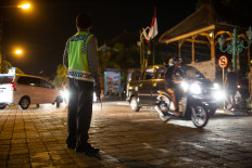 A police officer is seen on a road in Ubud, Bali on Sep. 6, 2016.