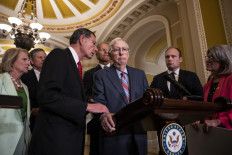 (Left-right) Sen. John Barrasso (R-WY) reaches out to help Senate Minority Leader Mitch McConnell (R-KY) after McConnell froze and stopped talking at the microphone during a news conference after a lunch meeting with Senate Republicans U.S. Capitol 26, 2023 in Washington, DC. Also pictured, L-R, Sen. Shelley Moore Capito (R-WV), Sen. Steve Daines (R-MT), Sen. John Thune (R-SD) and Sen. Joni Ernst (R-IA). McConnell was escorted back to his office and later returned to the news conference and answered questions.
