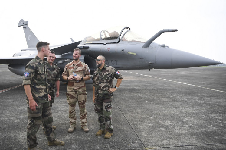 Several French military personnel gather next to a French Air Force's Rafale fighter jet at Halim Perdanakusuma Air Base in Jakarta on Wednesday, July 26, 2023. Two Rafale fighter jets and an Airbus A330 MRTT multirole tanker arrives in Jakarta as part of “Pegase 23“ training operation. 