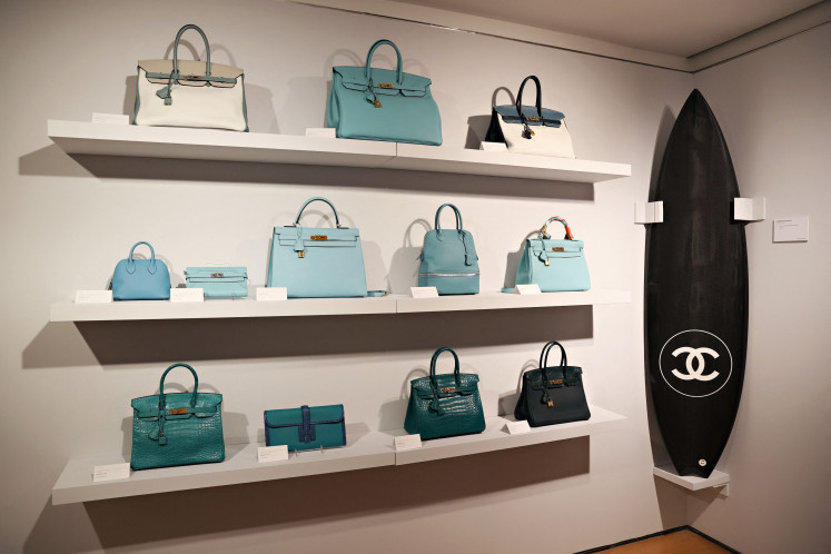 Hermès Birkin bags and a Chanel surfboard on display on June 04, 2021, during a press preview of the Luxury Week at Christie's in New York City, the United States. 