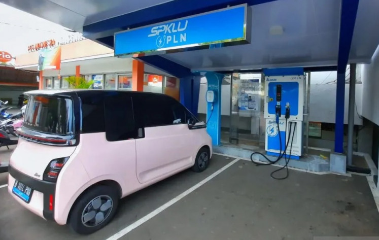 An electric car charges at a charging station belonging to state electricity company PLN.