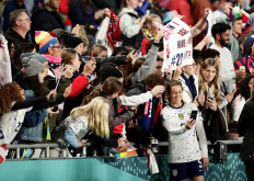Kelley O'Hara of the U.S. Women's National Soccer Team poses for selfies with fans after the match against Portugal on Aug. 1, 2023, as the United States qualify for the knockout stages of the 2023 Women's World Cup.