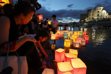 People release paper lanterns on the Motoyasu River beside the Hiroshima Prefectural Industrial Promotion Hall, commonly known as the atomic bomb dome, to mark the 78th anniversary of the world's first atomic bomb attack in Hiroshima on August 6, 2023.