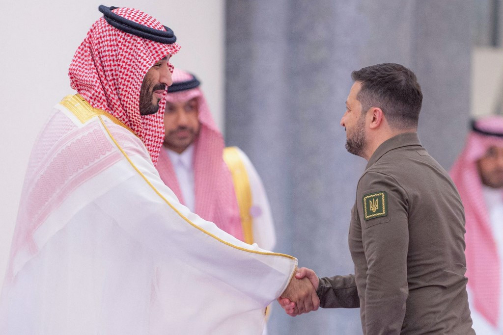 A handout picture provided by the Saudi Press Agency (SPA) on May 19, 2023 shows Saudi Crown Prince Muhammad bin Salman (left) welcoming Ukraine's President Volodymyr Zelensky during the Arab League Summit in Jeddah. Zelensky's surprise trip to the summit in the Red Sea coastal city of Jeddah was his first to the Middle East since Russia invaded Ukraine in February 2022.

