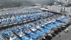 Fishing boats are seen anchored August 9, 2023, as they evacuate from typhoon Khanun at a port in Seogwipo on Jeju island, South Korea. 