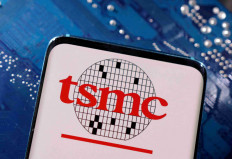 A smartphone with a displayed TSMC (Taiwan Semiconductor Manufacturing Company) logo is placed on a computer motherboard in this illustration taken March 6, 2023. 