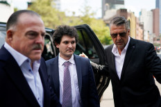 Sam Bankman-Fried (center), the founder of bankrupt cryptocurrency exchange FTX, arrives at court as lawyers push to persuade the judge overseeing his fraud case not to jail him ahead of trial, at a courthouse in New York, U.S., on August 11, 2023.