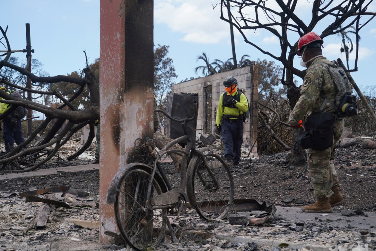 Members of the Hawaii National Guard assist Maui County and State officials in the search and recovery efforts after wildfires devastated the historic town of Lahaina, Maui, Hawaii, U.S., on Aug. 10, 2023.