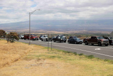 Vehicles are seen in traffic on  Kuihelani Hwy after officials allowed residents and tourists back into West Maui after a wildfire destroyed the historic town of Lahaina, in Maui, Hawaii, US, August 11, 2023.