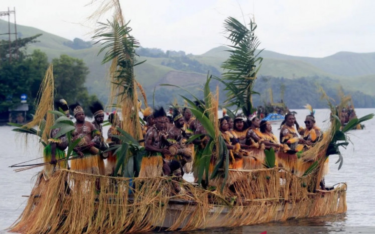 Members of a local indigenous community in Sentani, Papua, perform an Isosolo dance on July 5 during the opening of the 2023 Sentani Lake Festival in Khalkote area in Jayapura, Papua province.