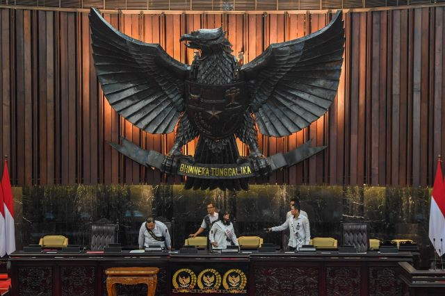 Employees of the House of Representatives Secretariat work under the Garuda Pancasila national emblem on Aug. 14, 2023 as they prepare the legislature ahead of the president’s annual State of the Nation Address scheduled for Aug. 16.