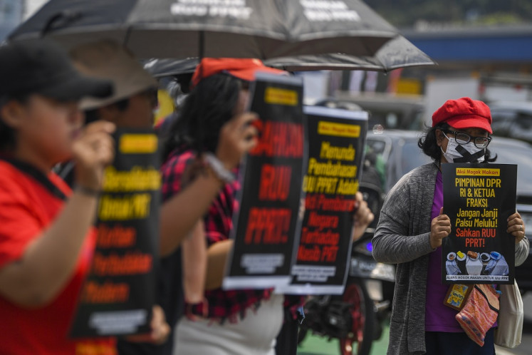 Protesters stage a hunger strike to urge the House of Representatives to pass the domestic workers protection bill in front of the legislative complex at Senayan, South Jakarta, on Aug. 14, 2023.