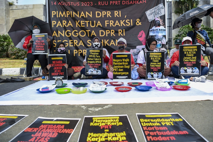 People hold a hunger strike during a protest at the Senayan legislative complex in South Jakarta on Aug. 14, 2023, demanding that the House of Representatives pass the bill on protection of domestic workers.