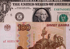 A view shows US one-dollar and Russian 100-rouble banknotes in this illustration picture taken August 14, 2023. 