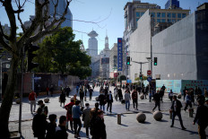 People walk at the main shopping area in Shanghai, China, on March 14, 2023.