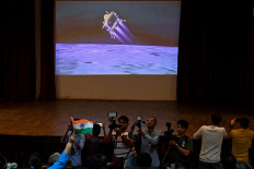 People watch a live stream aired by Indian Space Research Organisation (ISRO) website at the Nehru Science Centre in Mumbai on August 23, 2023, minutes before the successful lunar landing of Chandrayaan-3 spacecraft on the south pole of the Moon. 