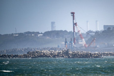 The Tokyo Electric Power Company's (TEPCO) crippled Fukushima Daiichi Nuclear Power Plant (back), is seen from Ukedo fishing port in Namie, Fukushima prefecture on Aug. 24, 2023. Japan began releasing wastewater from the crippled Fukushima nuclear plant into the Pacific Ocean on Aug. 24 despite angry opposition from China and local fishermen.