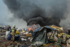 Firefighters try to extinguish a fire that has been burning for five days, causing air pollution for some 12,000 residents in the surrounding area, at the landfill in Sarimukti on the outskirts of Bandung, West Java on August 24, 2023. 
