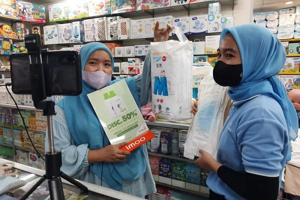 Employees of a pharmaceutical store promote baby care products through live streaming on Jan. 25, 2023, at ITC Fatmawati trade center in South Jakarta.