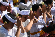 Balinese people pray during the Kuningan holiday, the last day of the Galungan celebrations that is believed to be the day when ancestral holy spirits ascend to heaven, at Sakenan temple on Serangan Island, Denpasar, on Aug. 12, 2023.