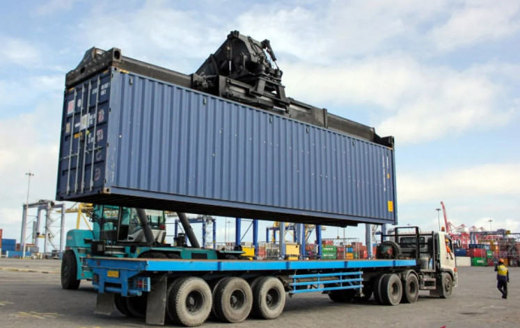Giant work: A truck carries a container of logistics to be used in the Powerboat Formula One race at Belawan Port in Medan, North Sumatra, in this file photo. The Indonesian Investment Authority, together with DPWorld, is investing in development of a new container terminal in Belawan.