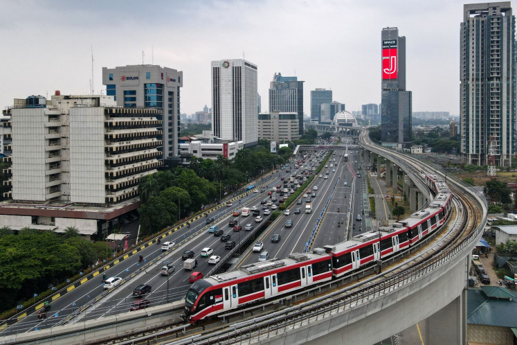 An aerial photo shows a Greater Jakarta LRT train passing over Jl. Gatot Subroto in Jakarta on Aug. 28, 2023.