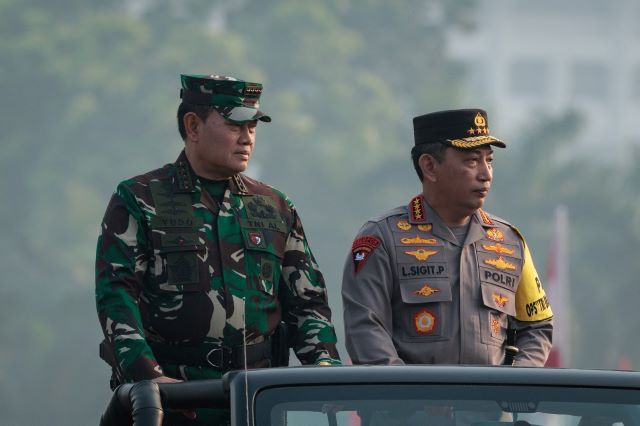 Indonesian Military commander Adm. Yudo Margono (left) and National Police chief Gen. Listyo Sigit Prabowo ride an open-bed vehicle on Sept. 1, during a ceremony at National Monument Park in Jakarta to form the combined military-police security detail for the 43rd ASEAN Summit.